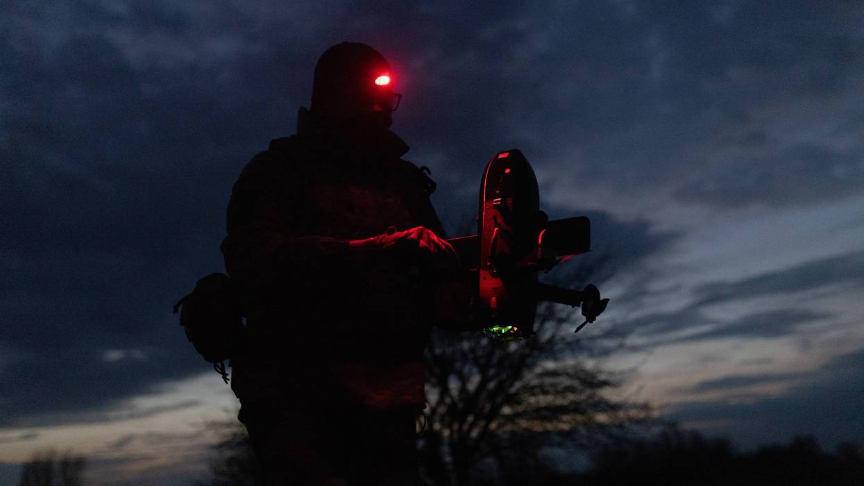 A Ukranian soldier prepares a drone.
