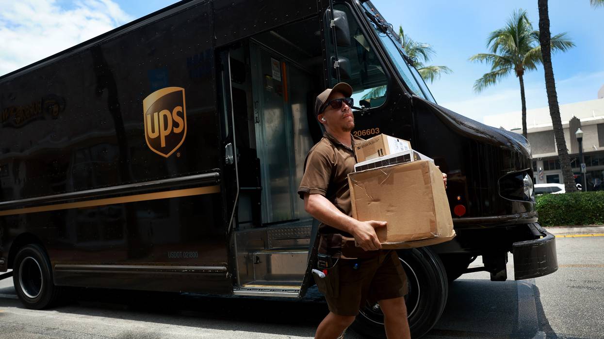 A UPS driver makes a delivery on June 30, 2023 in Miami, Florida.