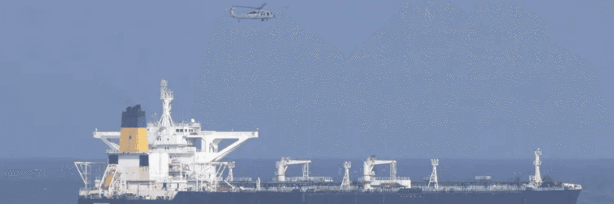 A US helicopter flies over an oil tanker at sea