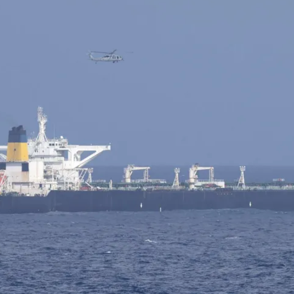 A US helicopter flies over an oil tanker at sea