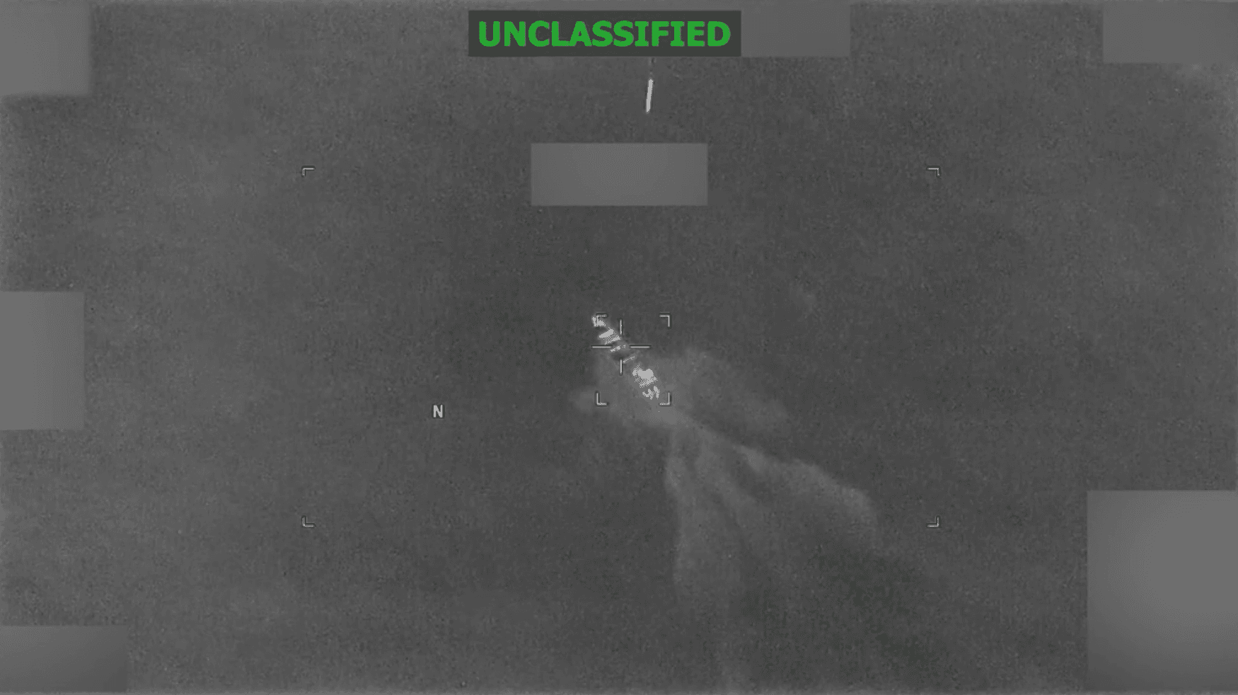 A US munition falls toward a boat in the Pacific Ocean in this grainy Pentagon video marked "unclassified"