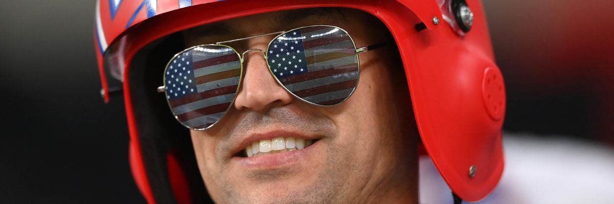 A USA fan wearing USA sunglasses and a Top Gun style helmet looks on during the FIFA World Cup Qatar