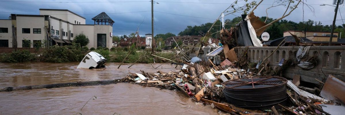 A van flows in floodwaters near the Biltmore Village