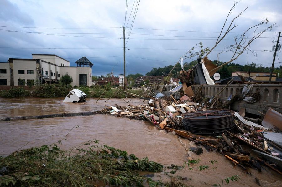 A van flows in floodwaters near the Biltmore Village