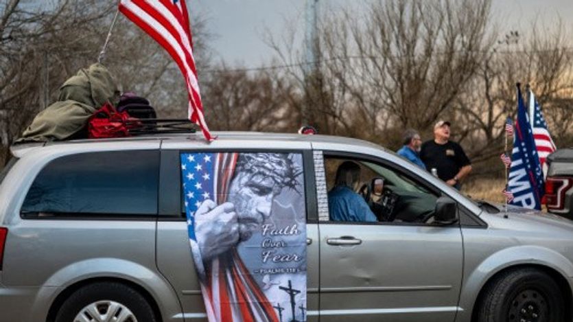 A van in the Take Back the Border convoy sports a barbed-wired Christ urging "Faith over Fear"  