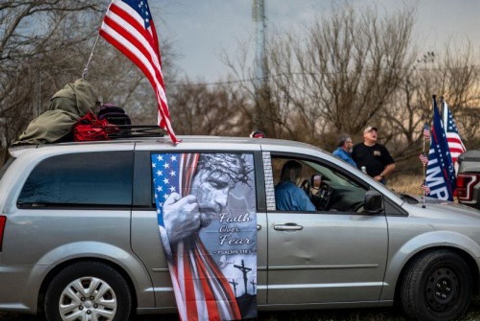 A van in the Take Back the Border convoy sports a barbed-wired Christ urging "Faith over Fear"  