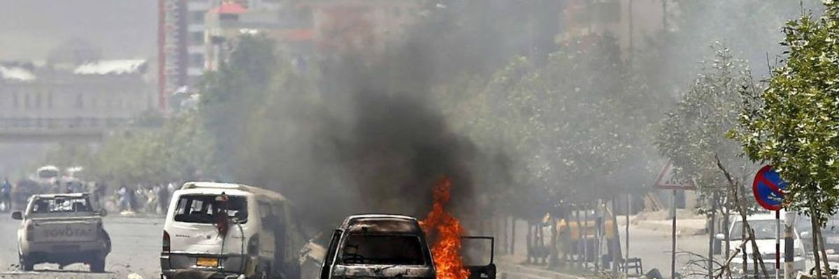 A vehicle burns after a blast near the parliament building in Kabul