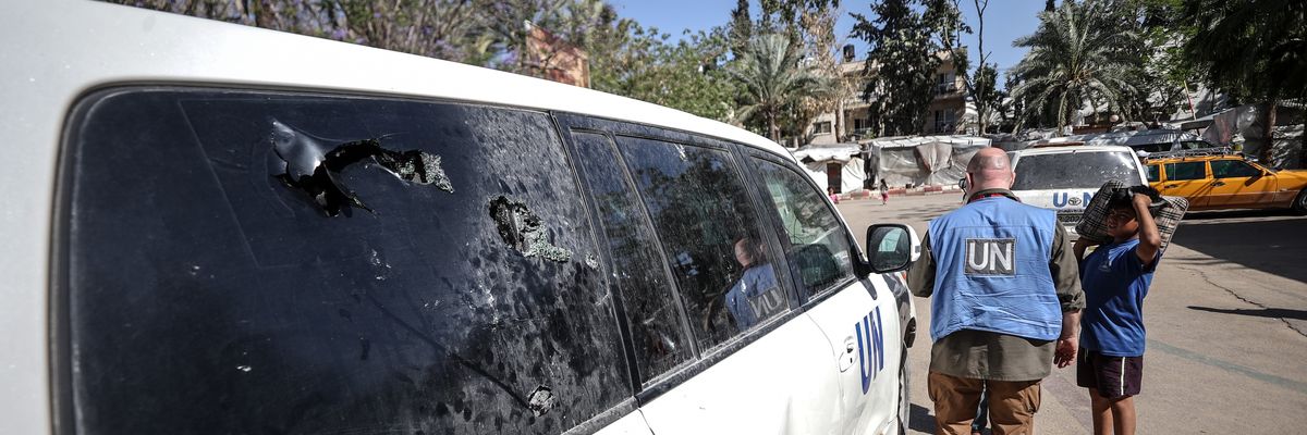 A view of a damaged UN vehicle in front of a hospital