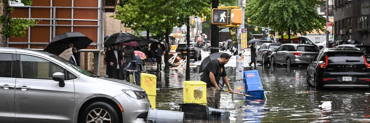 A view of a flooded street as people walk in New York City o