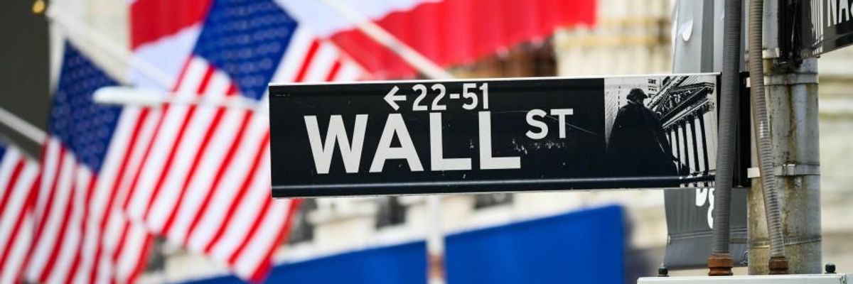 A view of the Wall Street street sign with the New York Stock Exchange