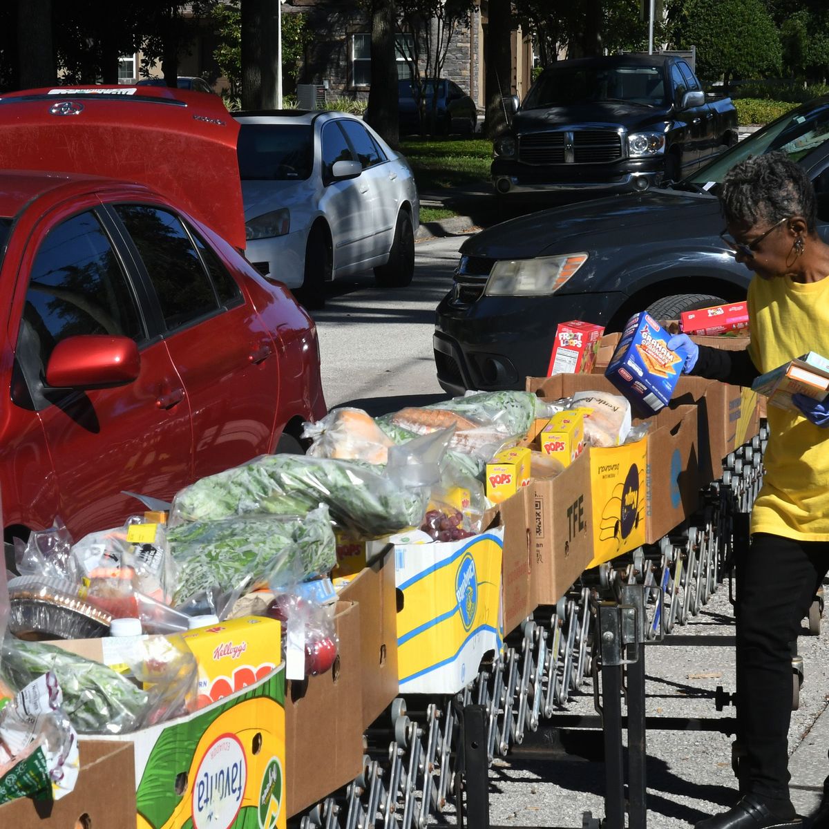 A volunteer prepares food packages at a distribution event in florida