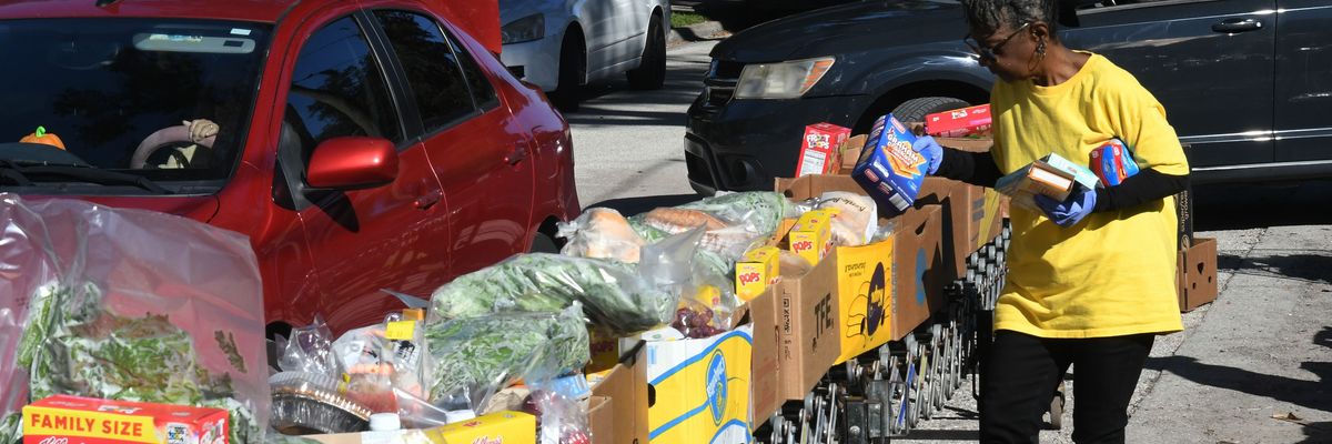 A volunteer prepares food packages at a distribution event in florida