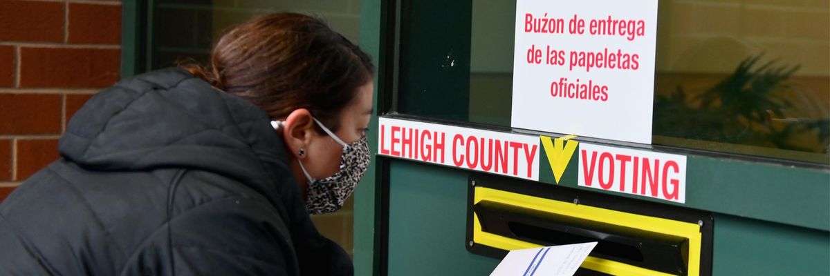 A voter drops off a ballot in Pennsylvania