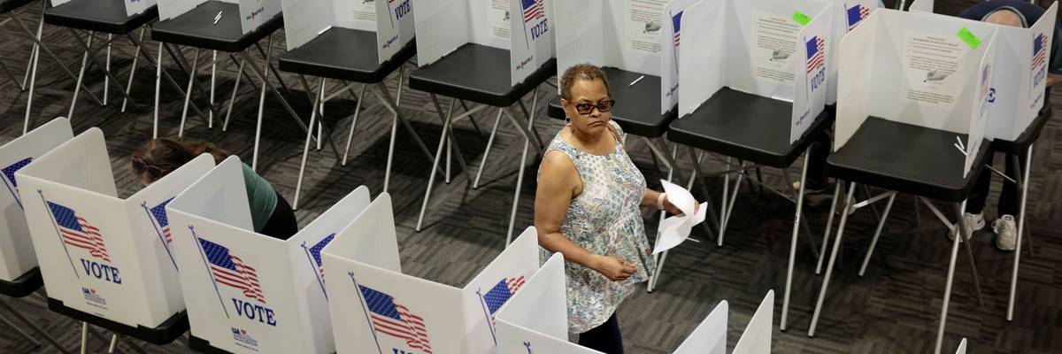 A voter leaves a booth.