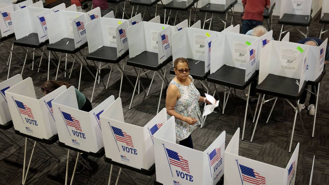 A voter leaves a booth.