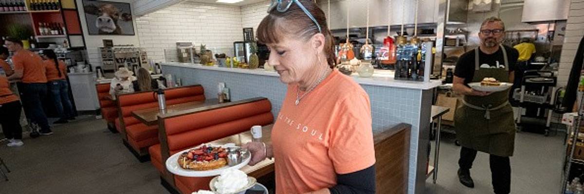 A waitress serves a meal at OEB Breakfast Co. in Newport Beach, California