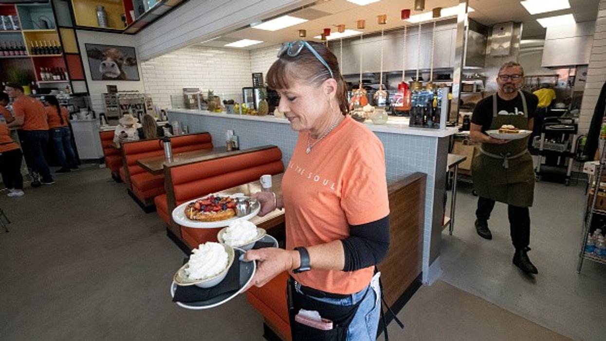 A waitress serves a meal at OEB Breakfast Co. in Newport Beach, California