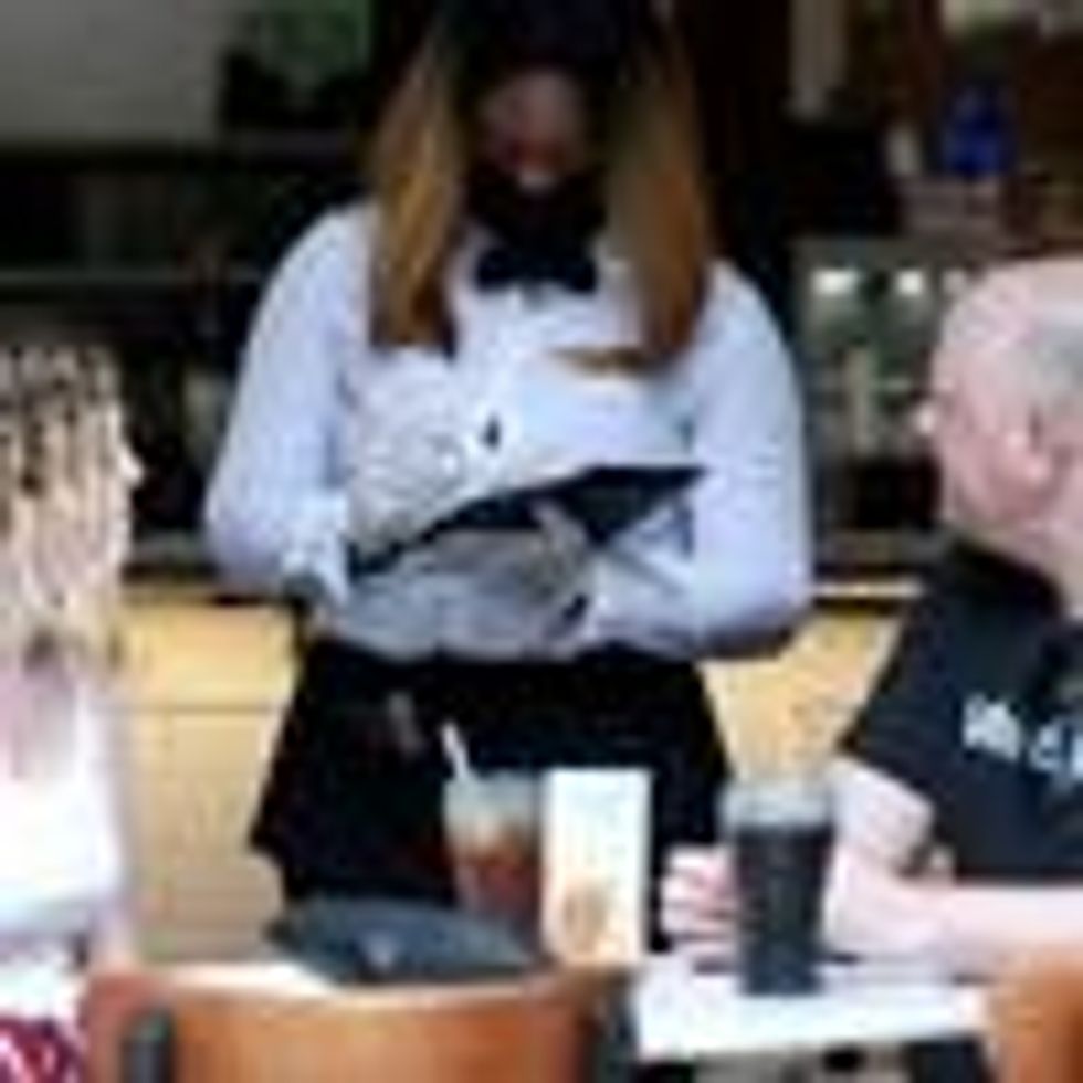 A waitress takes an order during lunch on May 22, 2020 at a restaurant in New Orleans. (Photo: Sean Gardner/Getty Images)