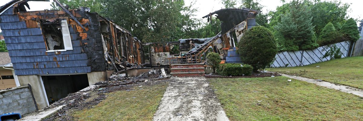 A walkway and front steps lead to a destroyed home in Lawrence, Massachusetts