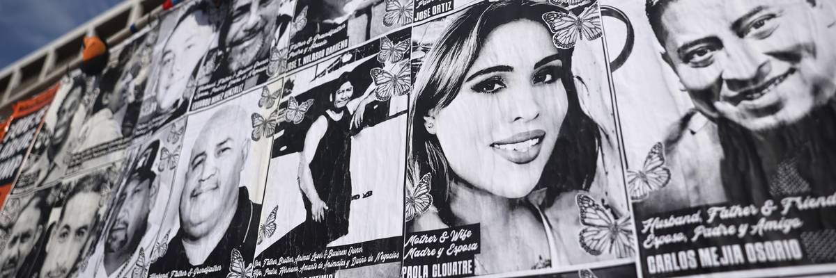 A wall with photos of people targeted by ICE.