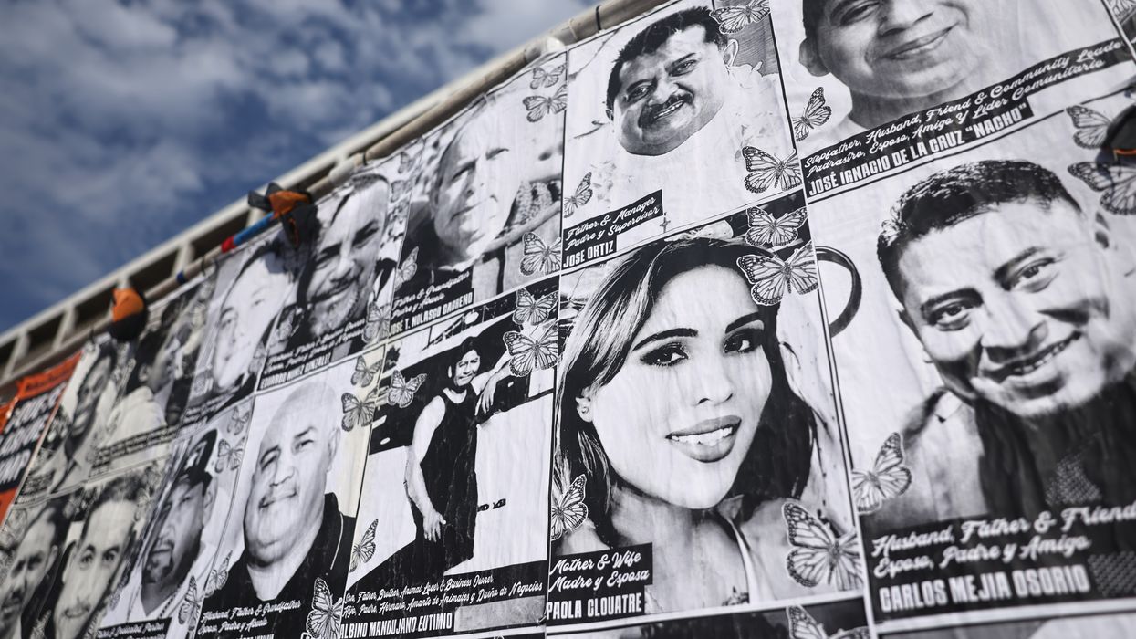 A wall with photos of people targeted by ICE.