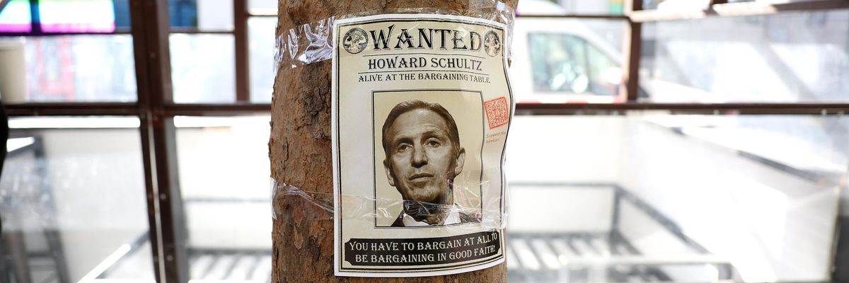 A "wanted" photo of Starbucks interim CEO Howard Schultz is posted on a tree