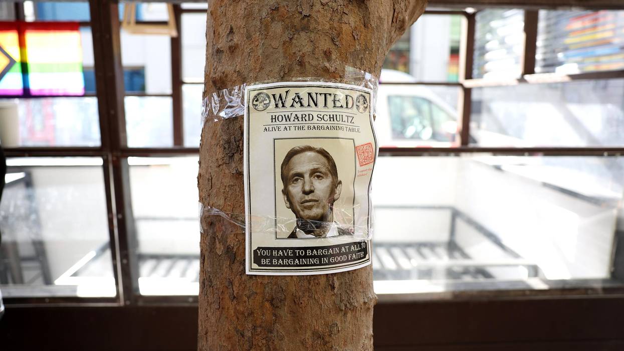 A "wanted" photo of Starbucks interim CEO Howard Schultz is posted on a tree