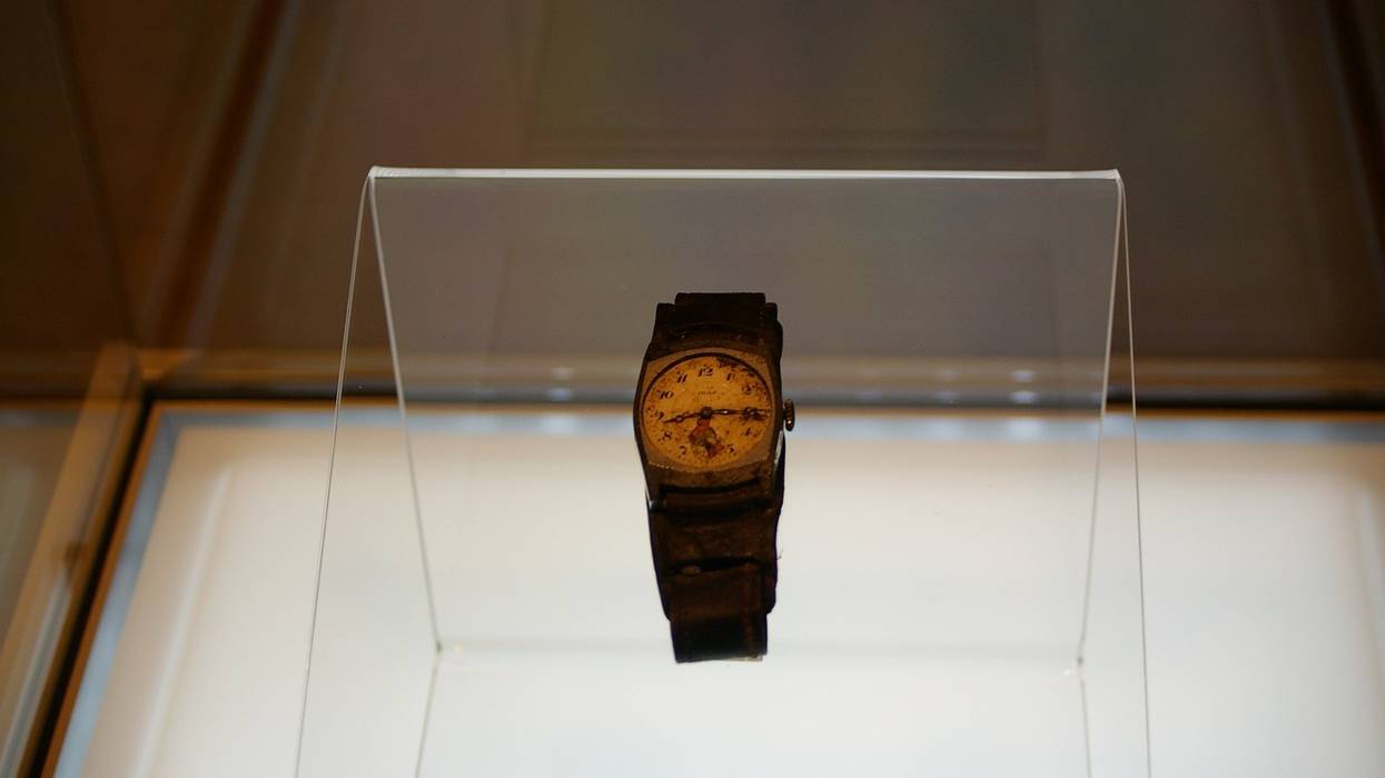 A watch stopped at the time of the Hiroshima bombing in a display case.