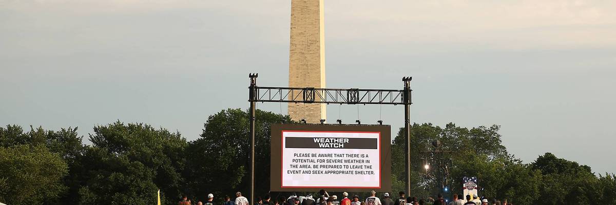 A weather watch sign in front of the Washington Monument.