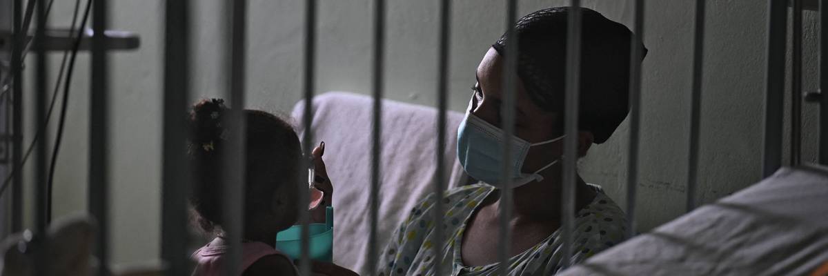 A woman cares for her daughter in a Cuban hospital