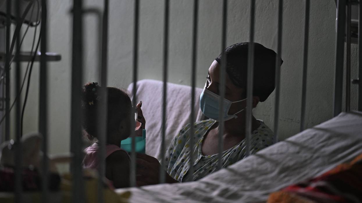 A woman cares for her daughter in a Cuban hospital
