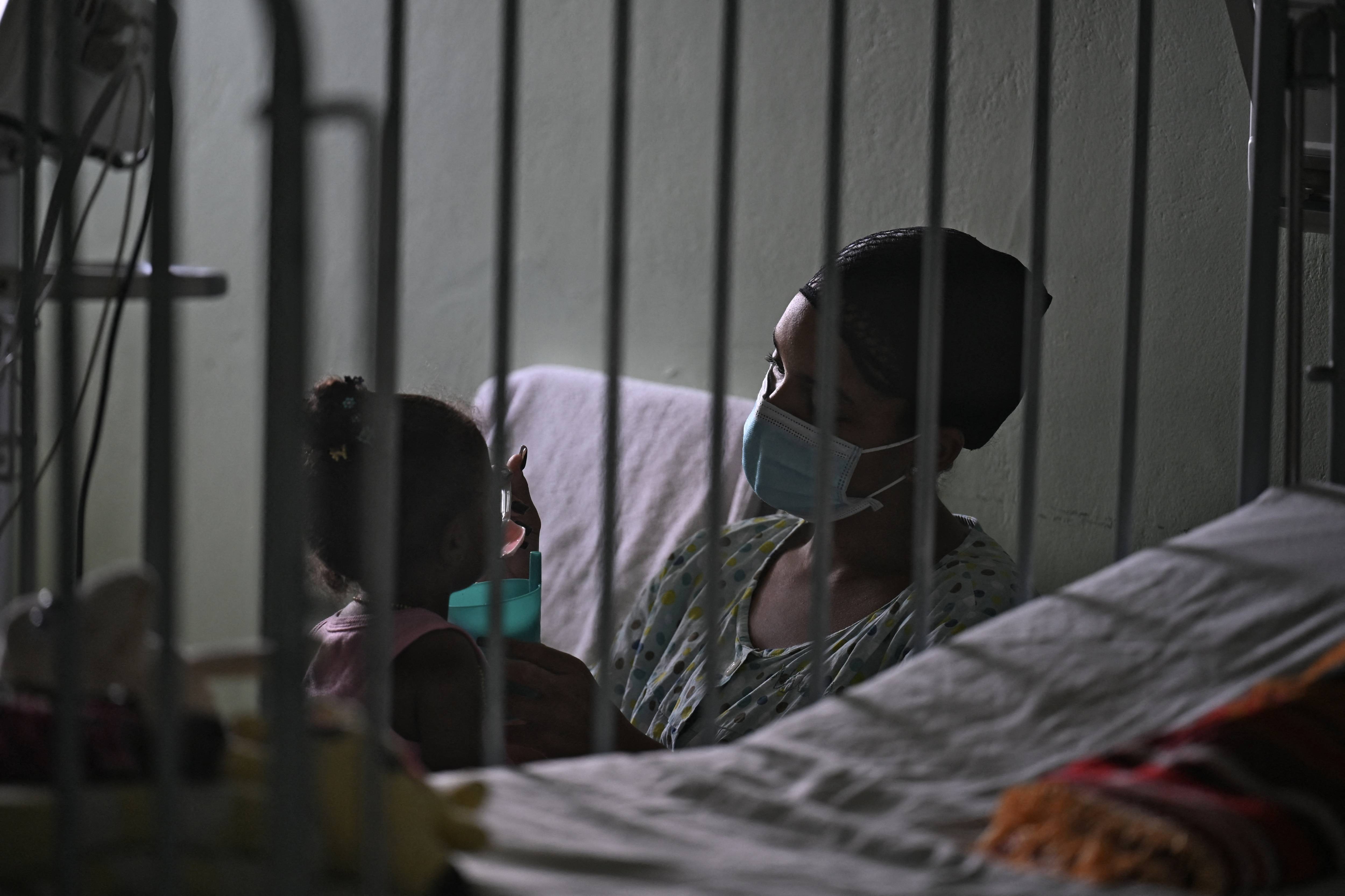 A woman cares for her daughter in a Cuban hospital