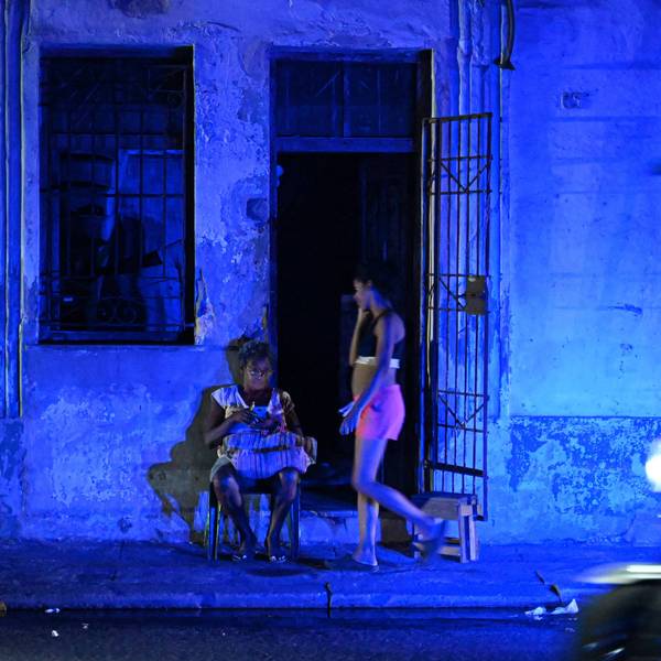 A woman checks a cell phone during a blackout in Havana, Cuba