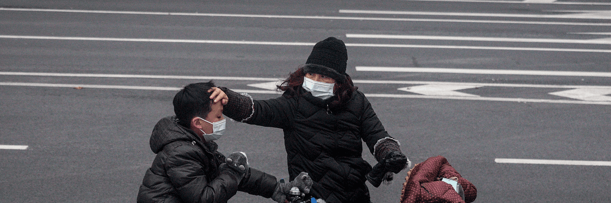 A woman checks her son's forehead on January 27, 2020 in Wuhan, China.