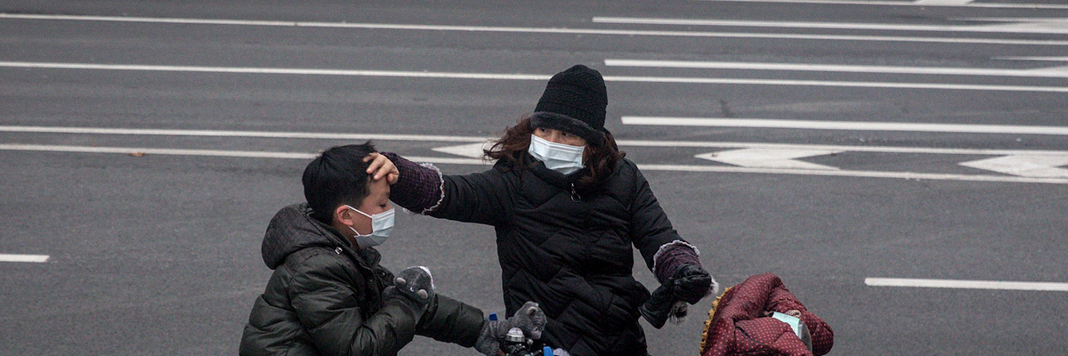 A woman checks her son's forehead on January 27, 2020 in Wuhan, China.