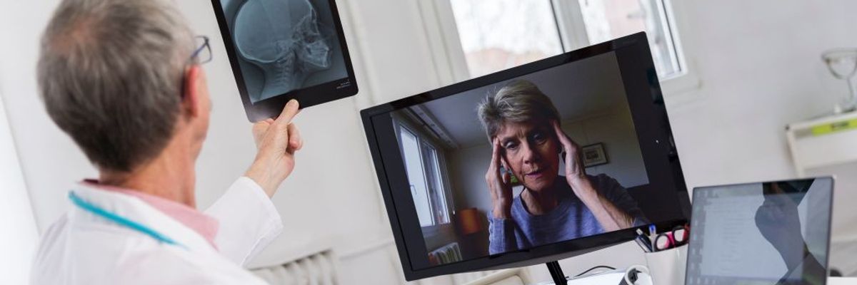 A woman consults a doctor via remote visit