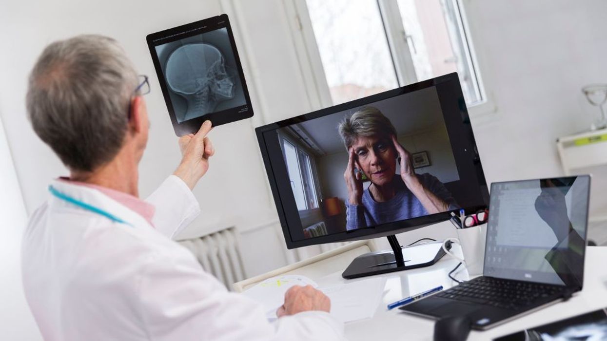 A woman consults a doctor via remote visit