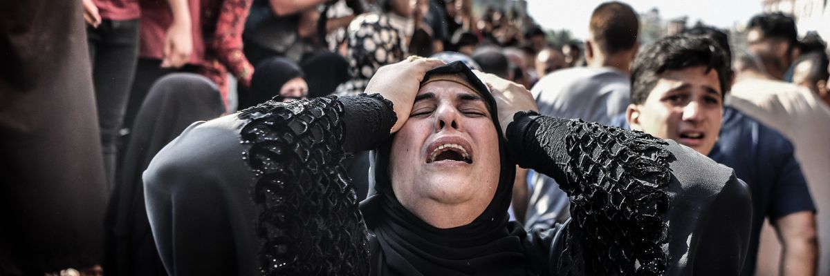 a woman cries during a funeral in gaza