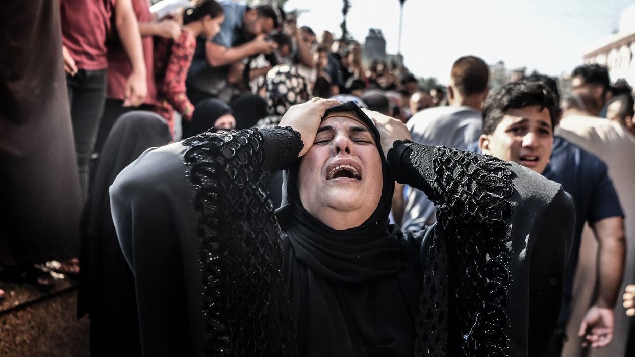 a woman cries during a funeral in gaza