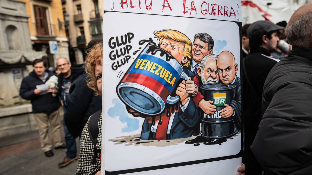 A woman holds a placard with the words "Stop the war" and