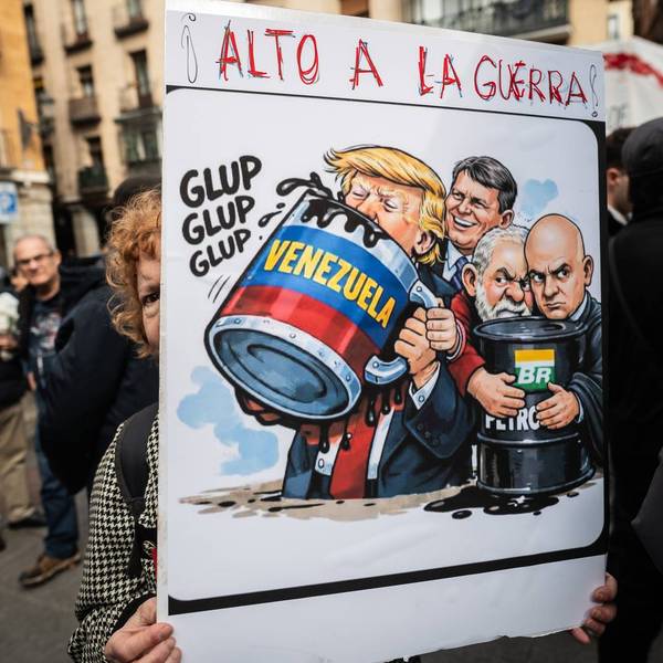 A woman holds a placard with the words "Stop the war" and