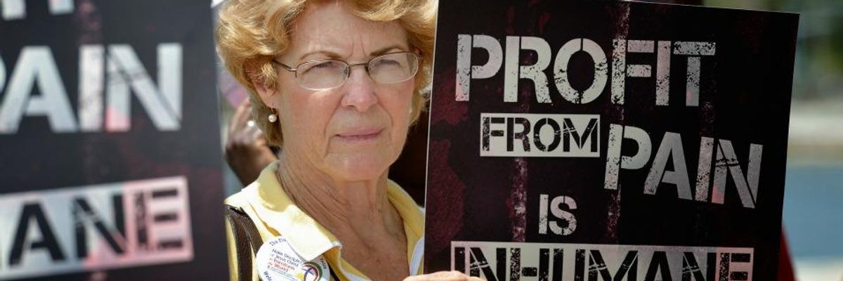 A woman holds a sign at a 2012 rally against private prisons