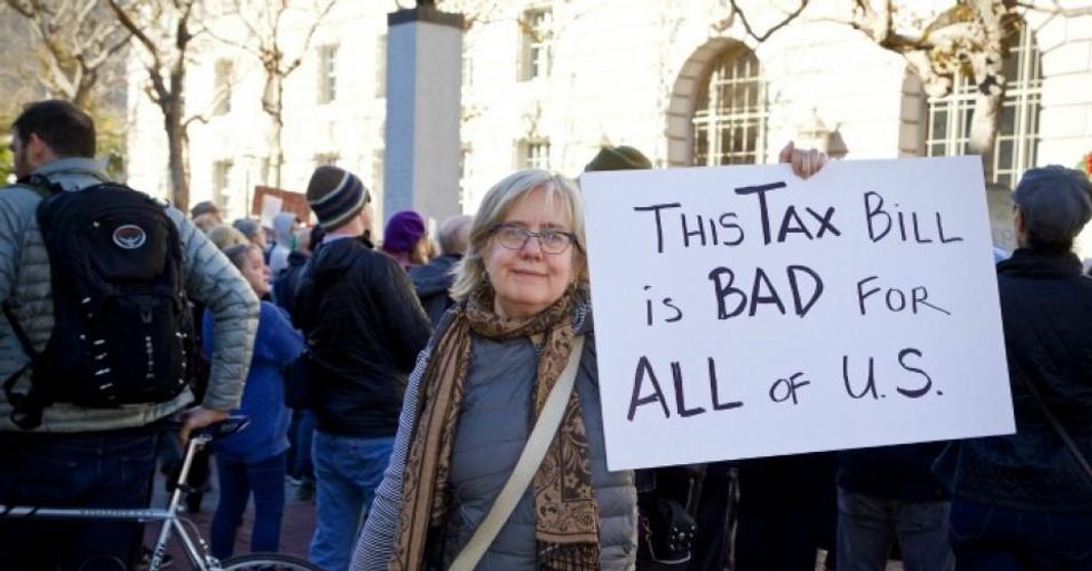 A woman holds a sign at a protest of the