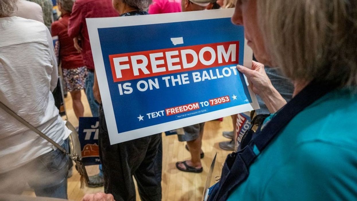 A woman holds a sign supporting an abortion rights ballot measure