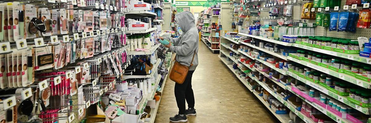 a woman in an aisle of Dollar Tree