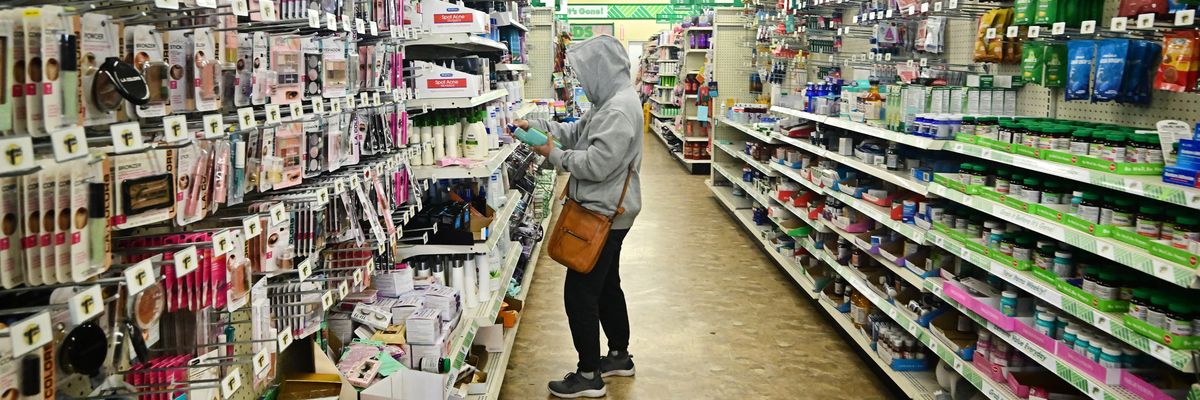 a woman in an aisle of Dollar Tree