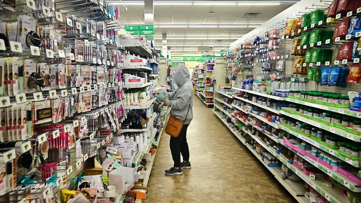 a woman in an aisle of Dollar Tree
