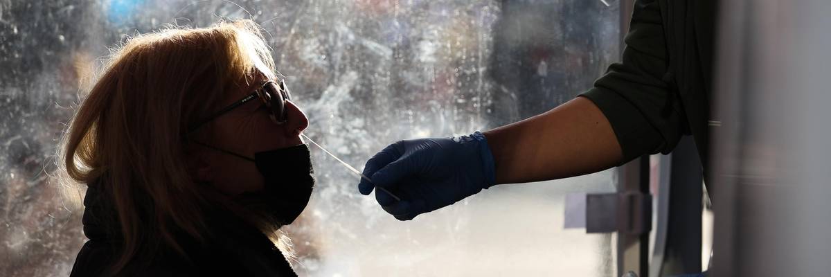 A woman in profile gets a Covid-19 test.