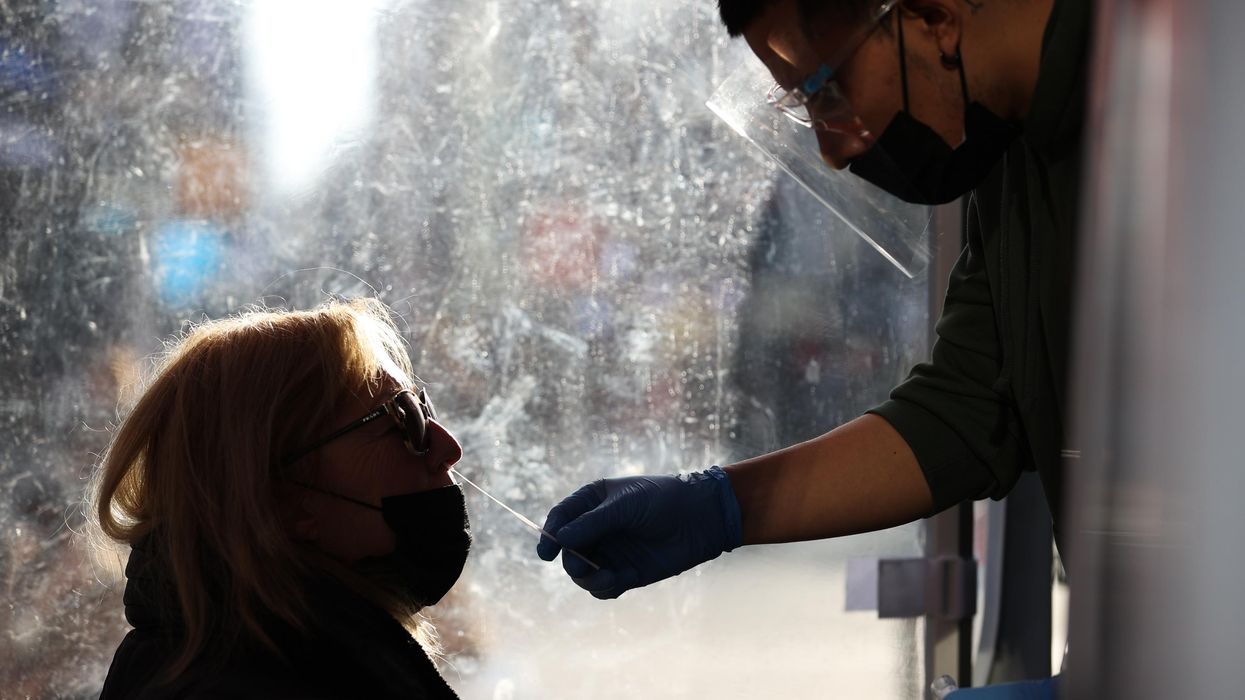 A woman in profile gets a Covid-19 test.