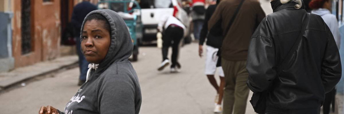 A woman in winter clothes in Havana.